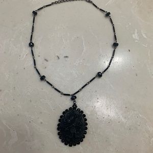 Black raised floral amulet-style beaded necklace